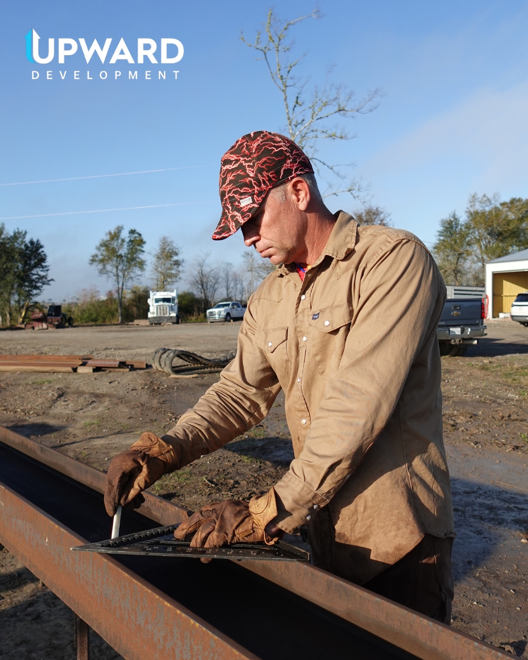 Upward Development team member marking a steel beam on a job site
